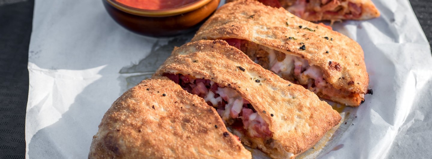 meat stromboli served with marinara sauce