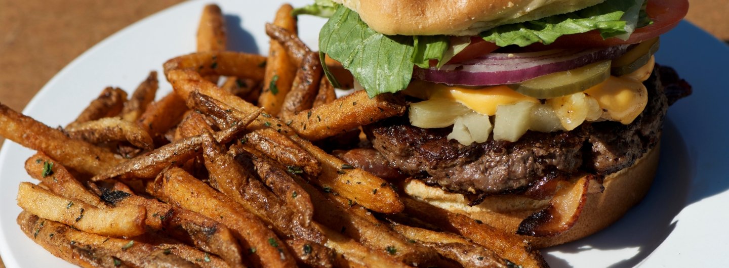 hawaiian burger topped with letuce tomatoe and onions